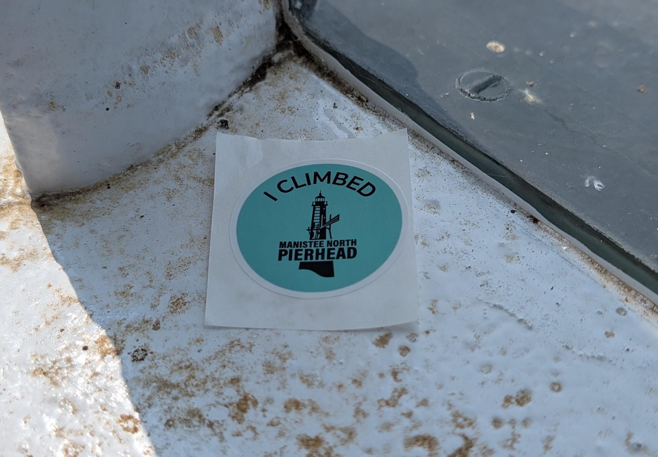 Sticker that says "I Climbed the Manistee North Pierhead"
