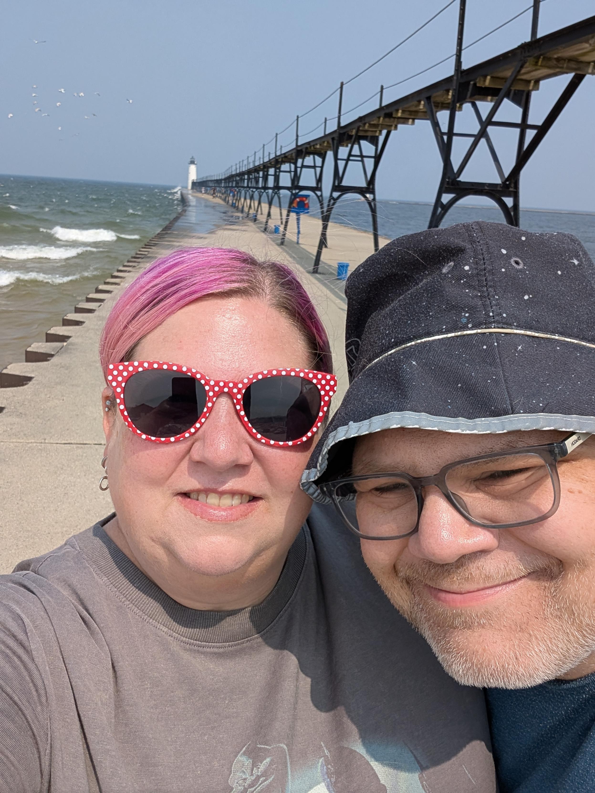 Wife and I on the pier heading out the the Manistee Lighthouse.